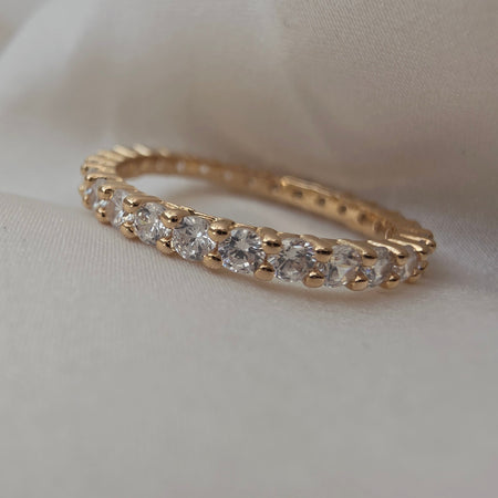 Bague dorée avec pierres brillantes serties