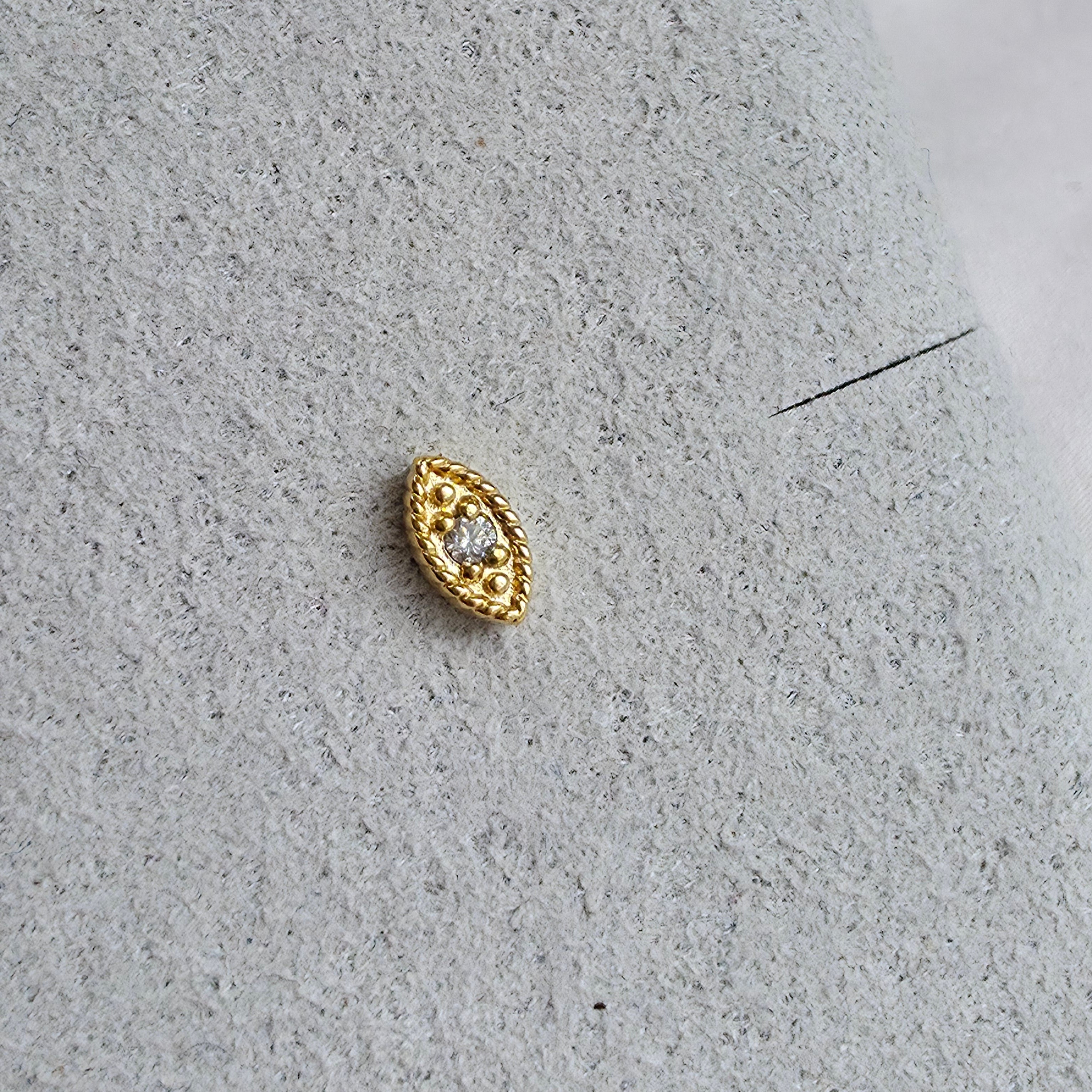 Zoom sur le piercing doré mystérieux