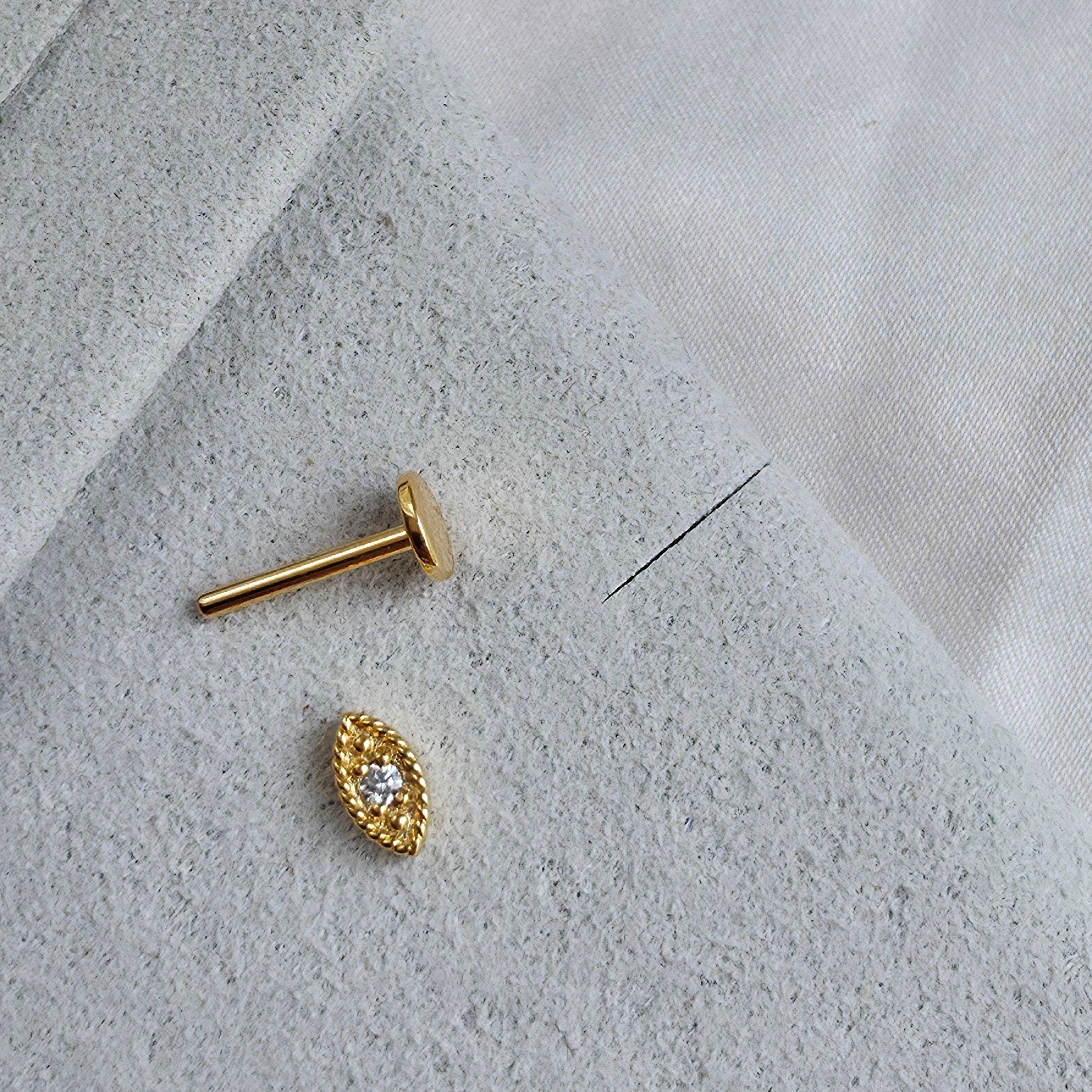 Zoom sur le piercing doré mystérieux