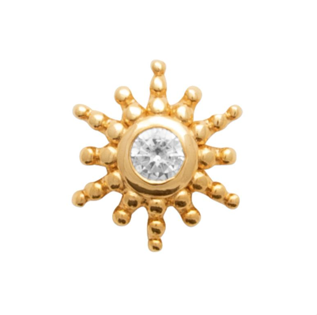 Piercing doré en forme de soleil avec zircon central