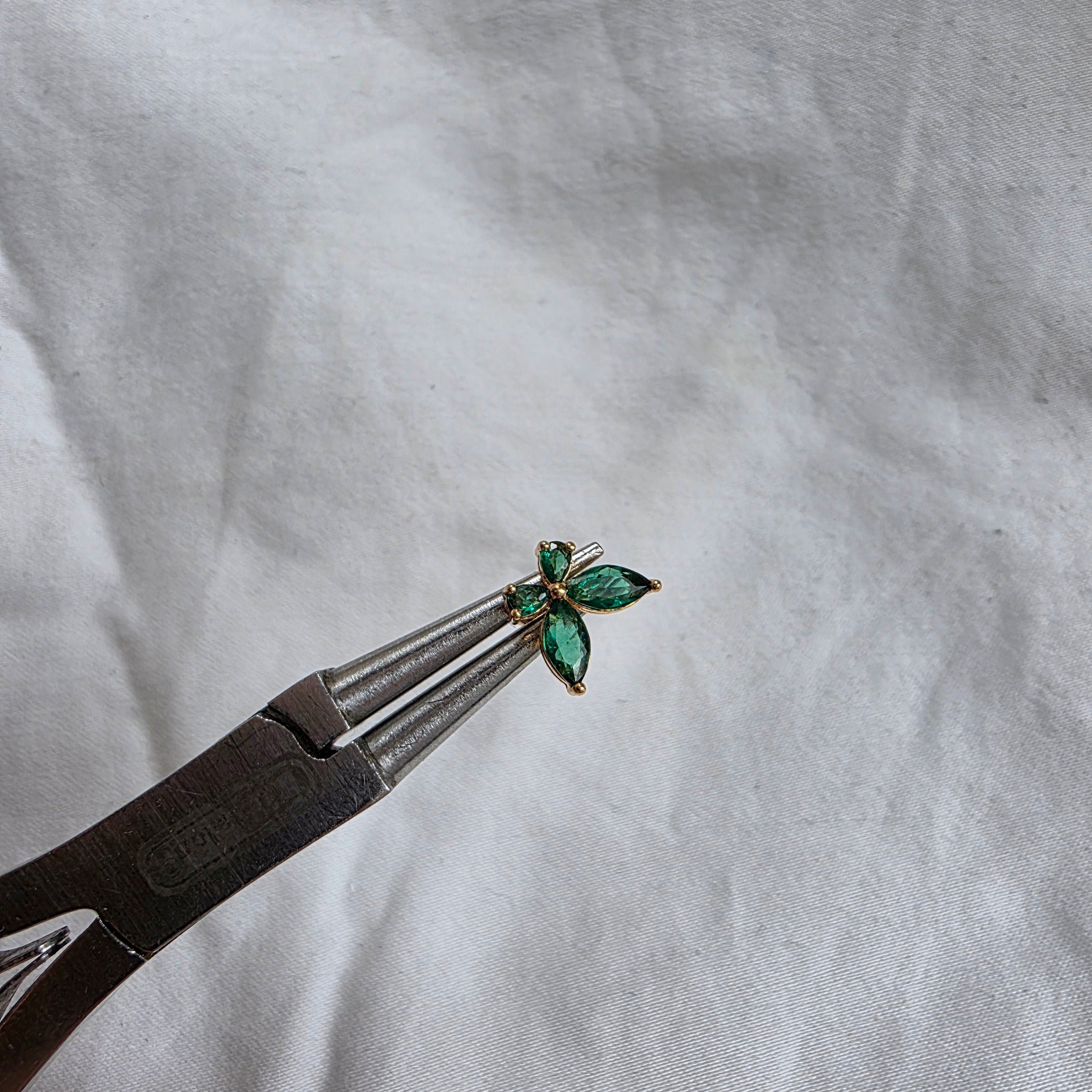 Puce d’oreille dorée avec pierres vertes