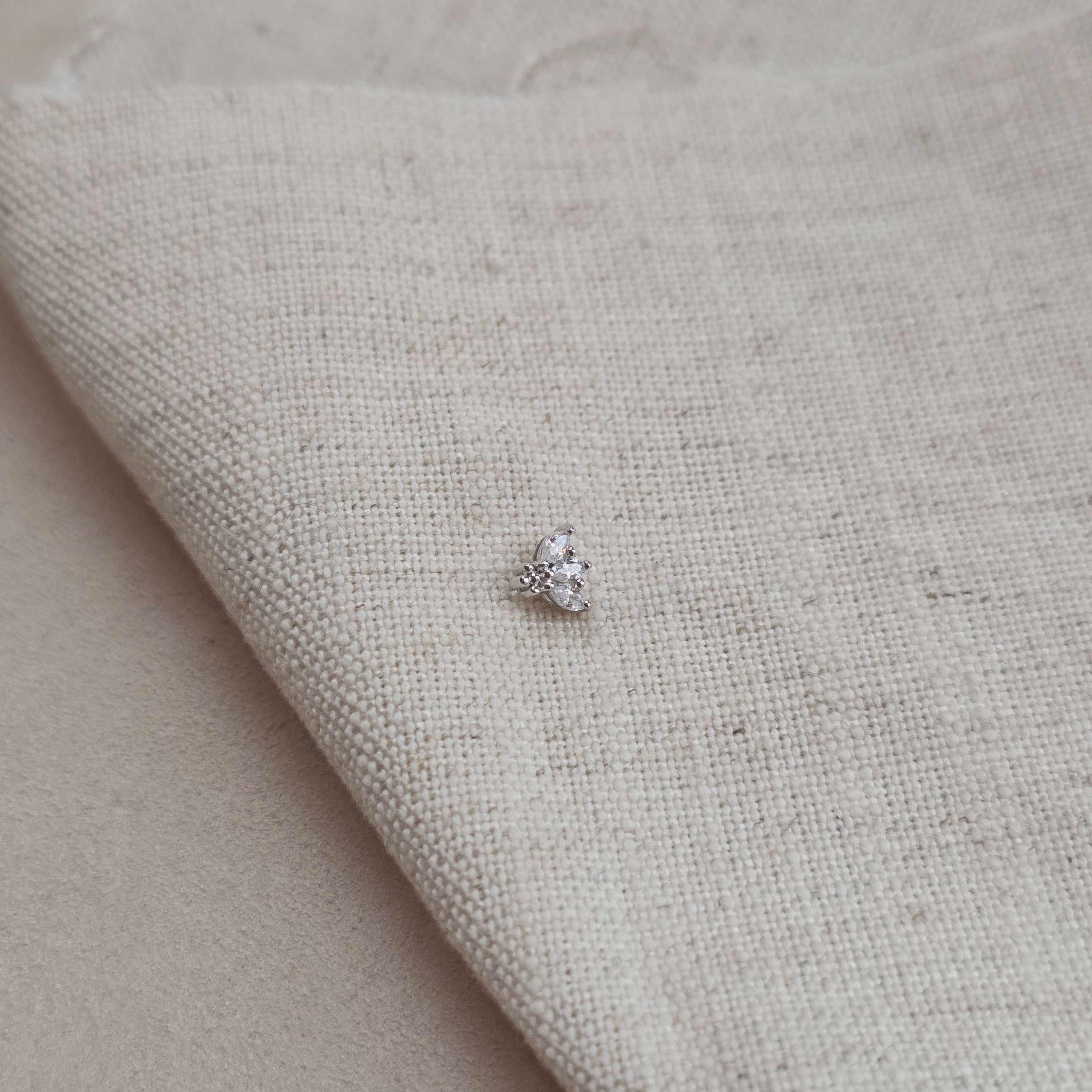 Orlane – puce d’oreille fine posée sur un tissu naturel